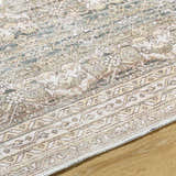 Close-up of Billie Vintage Flat Pile Washable Rug. Cream, green, and peach floral pattern with traditional border. Texture