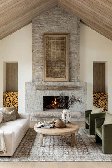 Living room scene with a Bartek Washable Area Rug, fireplace, white sofa, olive green chairs, and a round coffee table. Roomscene-Rectangle