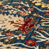 Close-up of the Neola Navy Blue Damask Area Rug. Details include red, tan, and yellow floral patterns on a navy background. Texture