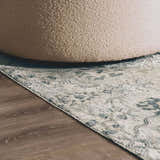 Close-up of the Barkisland Thick Luxe Oushak Rug in light beige, teal, and gray with a floral pattern and a textured weave. Styleshot