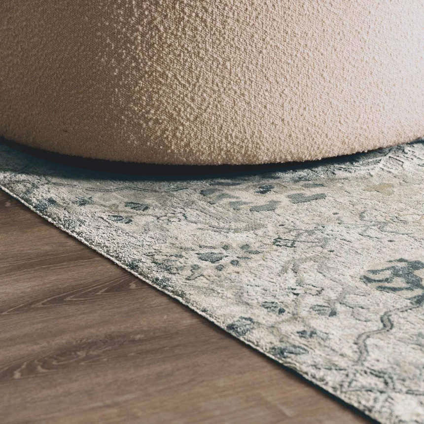 Close-up of the Barkisland Thick Luxe Oushak Rug in light beige, teal, and gray with a floral pattern and a textured weave. Styleshot