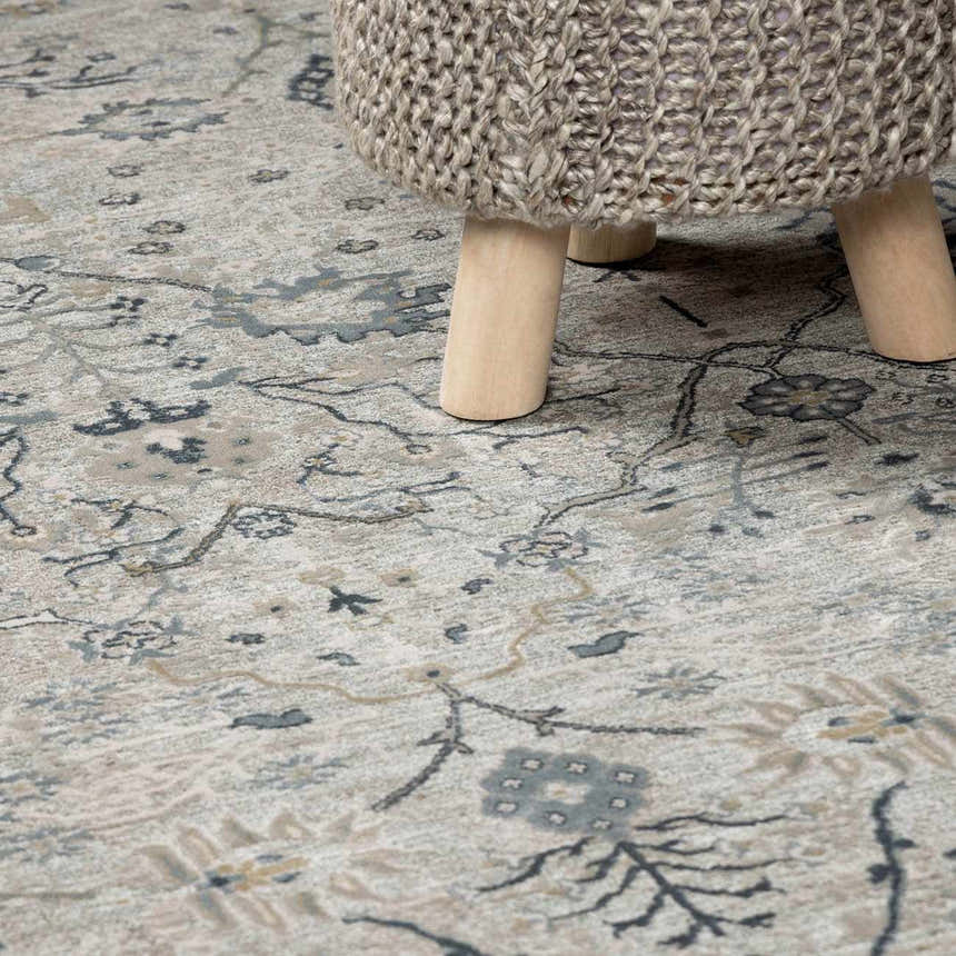 Close-up of the Barkisland Thick Luxe Oushak Rug in light beige, teal, and gray with a floral pattern and a textured weave. Styleshot