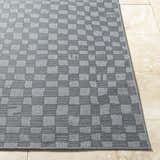 Close-up of the Arifah Gray Area Rug with a checkered pattern and textured weave on a tile floor. Front