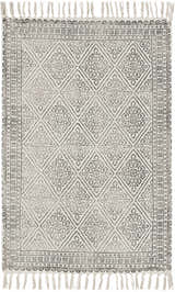 Close-up of the Brushton Area Rug. Beige cotton rug with a black geometric diamond pattern and tassels. Hand woven. Design-Rectangle-23