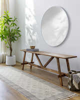 Entryway with Brushton Area Rug runner, wood bench, round mirror, and potted plant for a bright, contemporary look. Roomscene-Runner