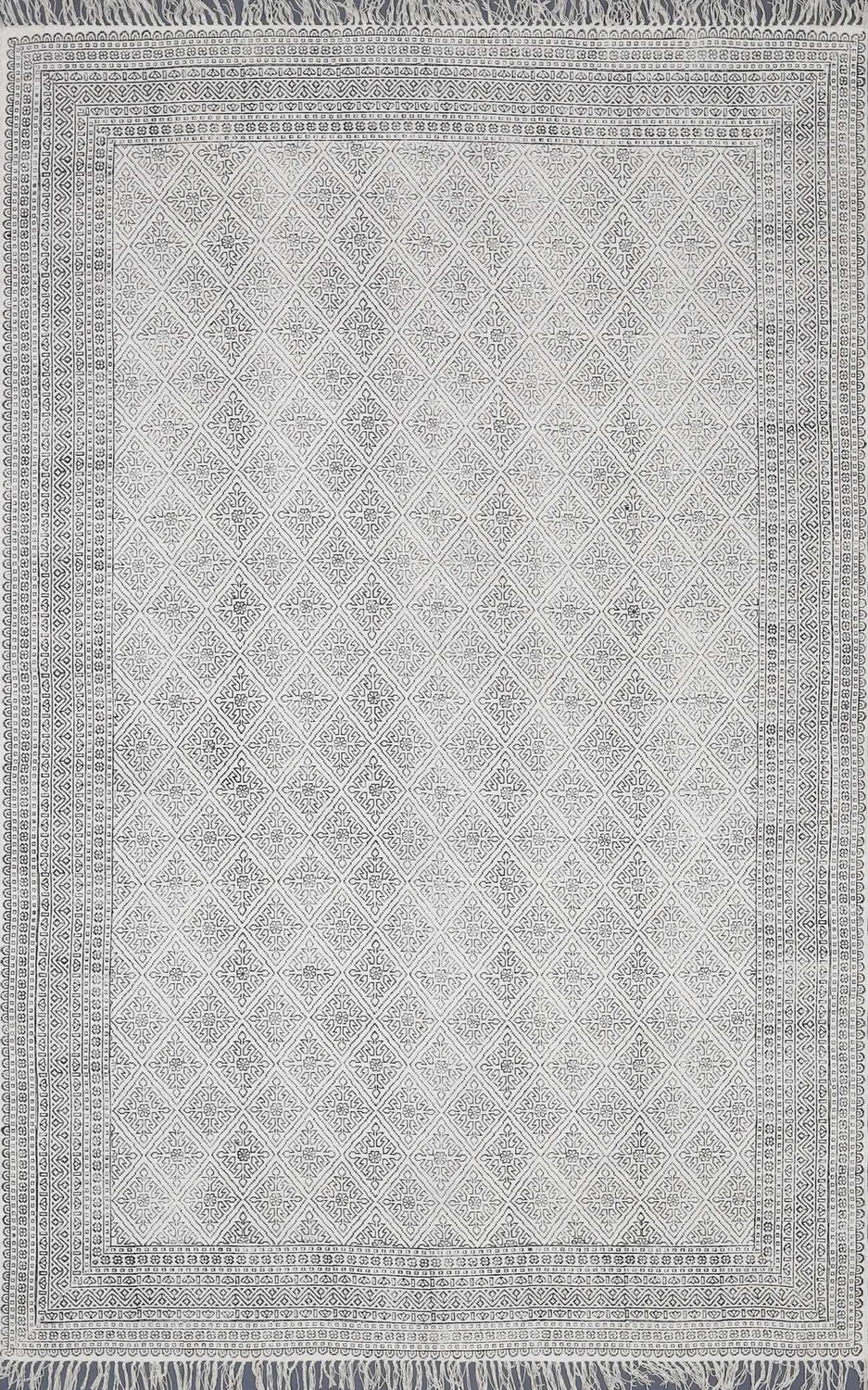 Close-up of the Brushton Area Rug. Beige cotton rug with black diamond and floral pattern and fringed edges. Design-Rectangle