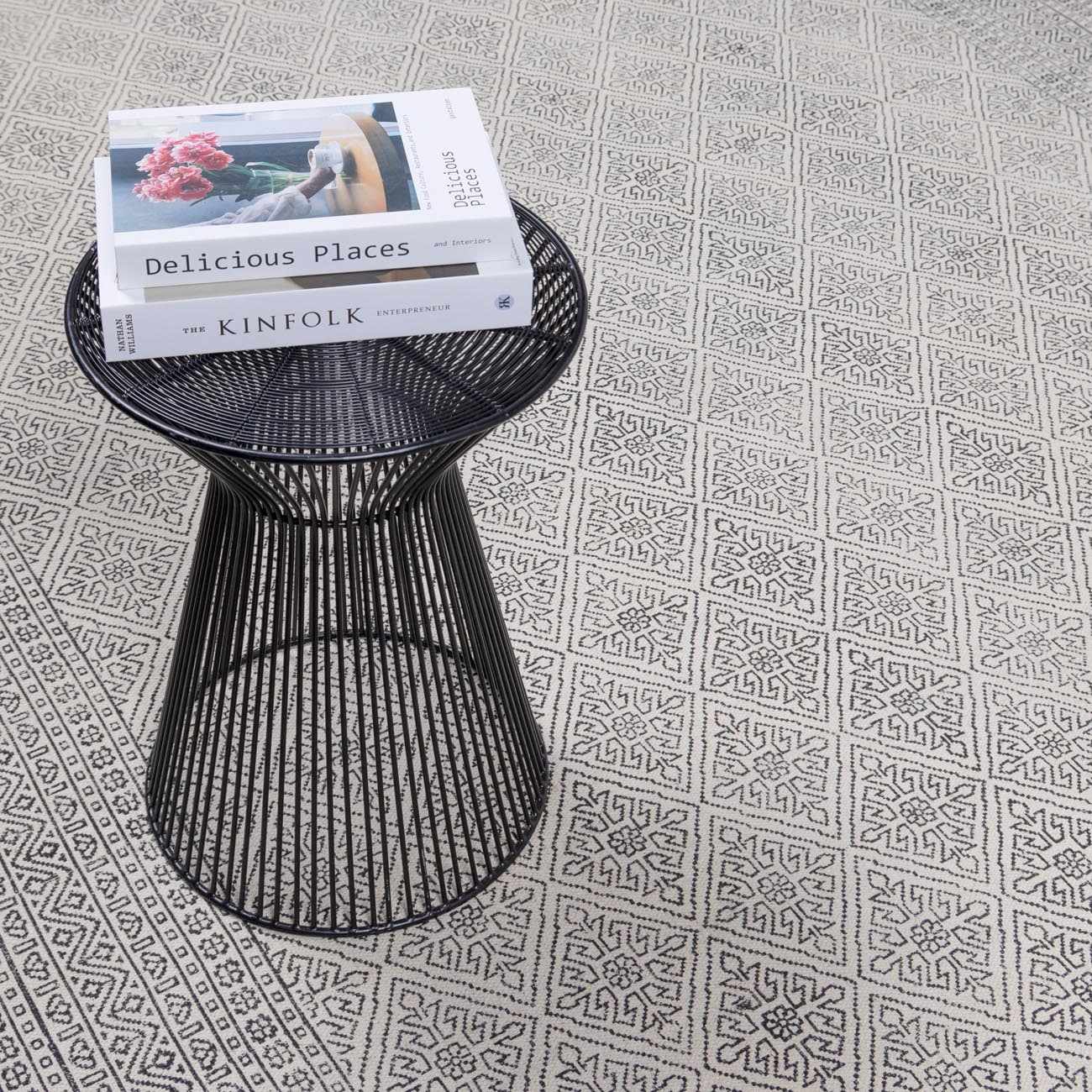 Close-up of the beige and black geometric pattern on the hand woven cotton Brushton Area Rug. Styleshot