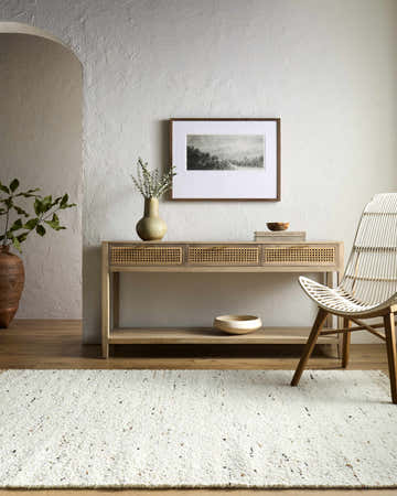 Entryway scene with a light wood console table and the Andrey Beige Area Rug. Roomscene-Rectangle
