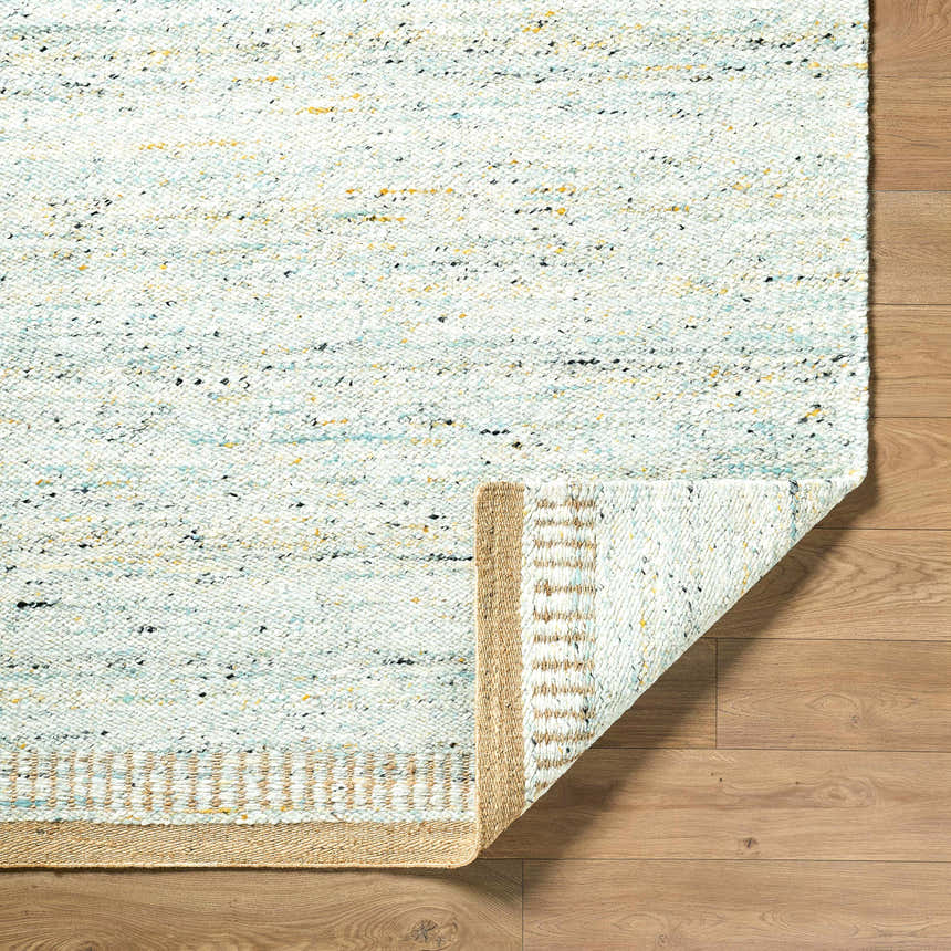 Close-up of the hand woven Andrey Dark Beige Area Rug showing charcoal, light and medium brown tones and wool texture. Fold