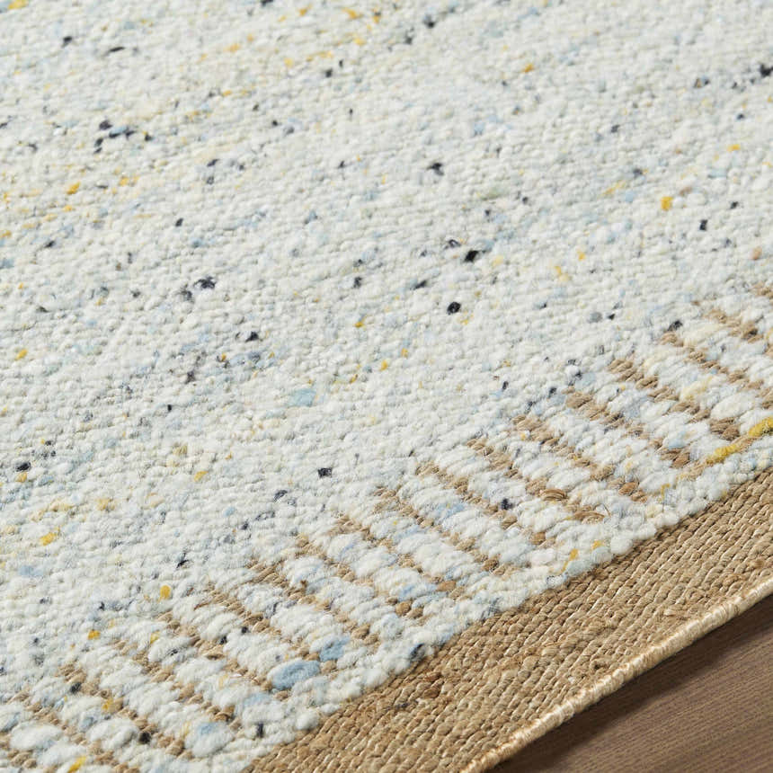 Close-up of the hand woven Andrey Dark Beige Area Rug, showing charcoal, light brown, and medium brown tones. Texture