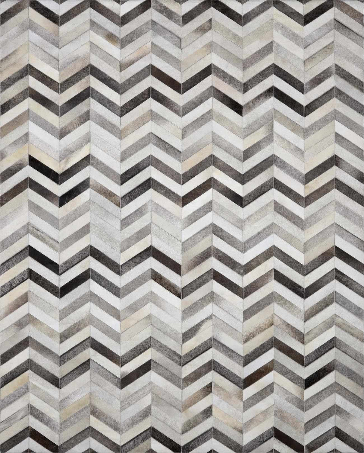 Close-up of the Bristolville Premium Leather Rug. Hair on hide rug with a gray, taupe, and brown chevron pattern. Design-Rectangle