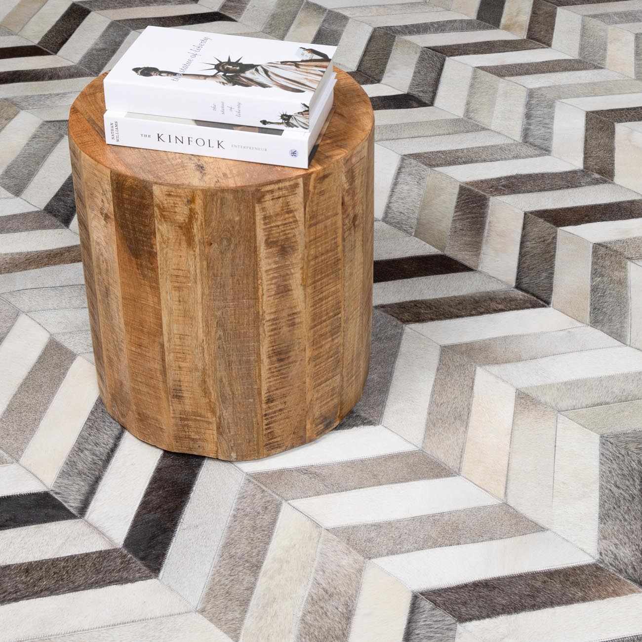 Close-up of the Bristolville Premium Leather Rug featuring a chevron pattern in charcoal, gray, and tan hues. Styleshot