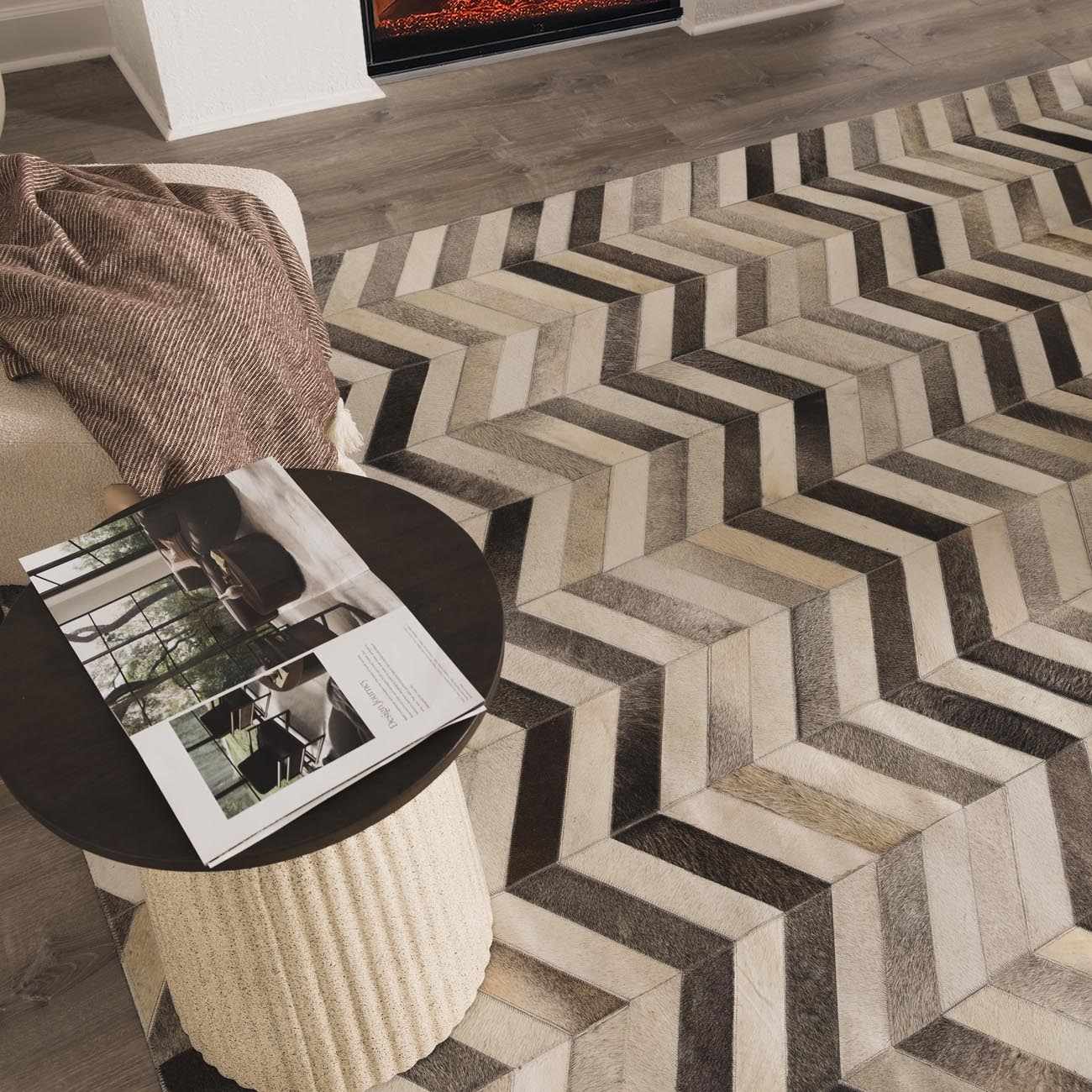 Living room scene with a Bristolville Premium Leather Rug featuring a gray chevron pattern. Styleshot