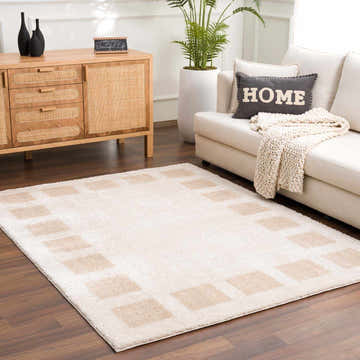 Living room scene with a beige sofa and the Beynon Beige Washable Area Rug featuring a square pattern. Roomscene-Rectangle