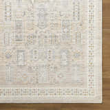 Close-up of the Fugia Beige Persian rug showing the traditional pattern, neutral colors, and machine woven texture. Corner