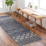 Entryway with Bunclody Jute Carpet runner in light beige and navy. Bohemian rug on wood floor with bench and plants. Roomscene-Runner