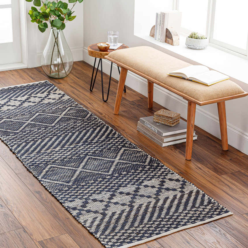 Entryway with Bunclody Jute Carpet runner in light beige and navy. Bohemian rug on wood floor with bench and plants. Roomscene-Runner