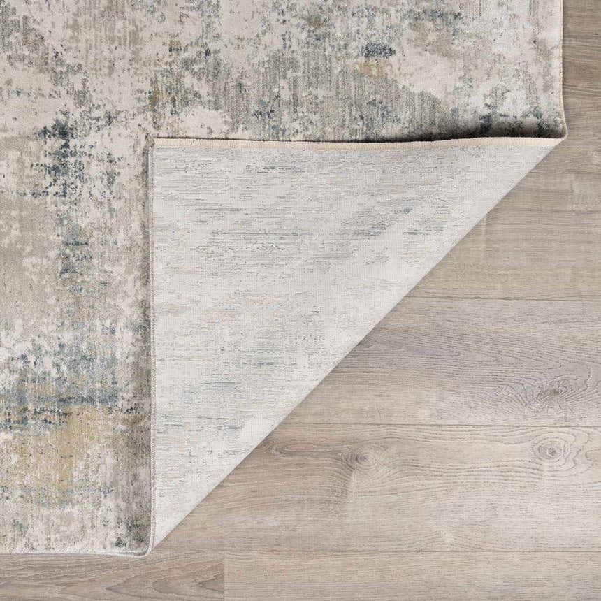 Close-up of the Burstwick Thick Luxe Boutique Rug showing its dusty sage, navy, and taupe abstract design and woven texture. Fold