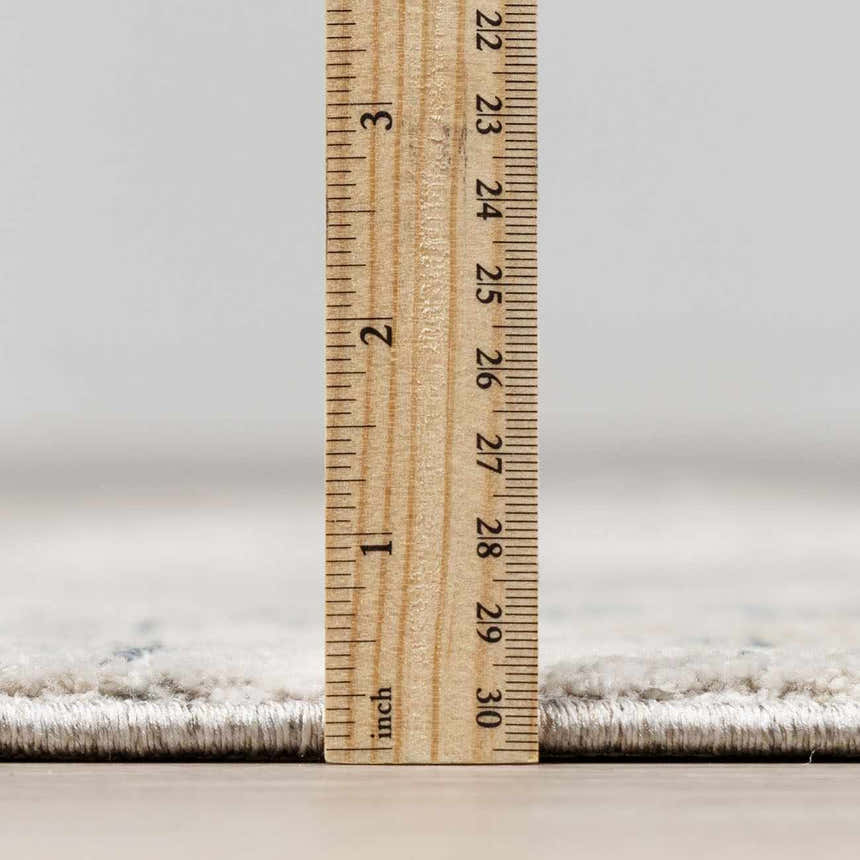 Close-up of the pile height of the Dusty Sage Burstwick Thick Luxe Boutique Rug, next to a ruler. Pile