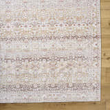 Close-up of Bienna Vintage Flat Pile Washable Rug showing camel, cream, and brown traditional pattern and flat pile texture. Corner