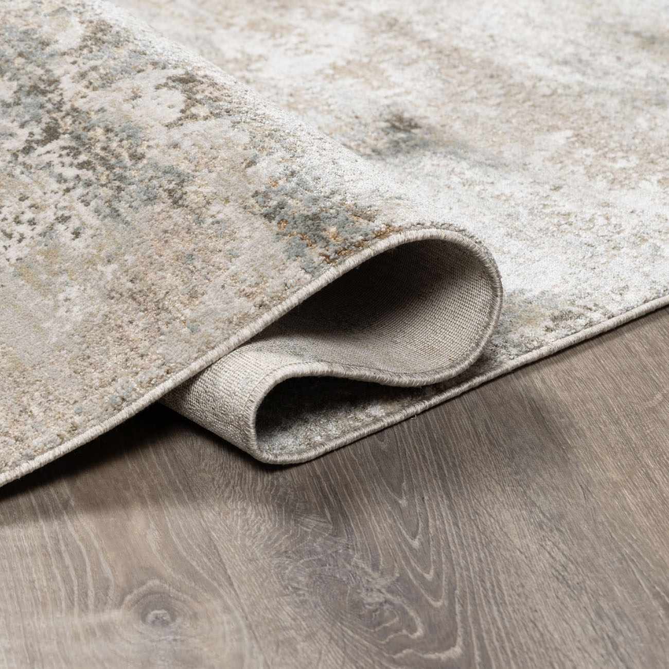 Close-up of the charcoal and sage Bowdoinham Thick Luxe Boutique Rug showing its texture and woven backing. Fold