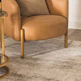 Living room scene with a tan leather chair on a neutral Bowdoinham Thick Luxe Boutique Rug. Roomscene-Rectangle