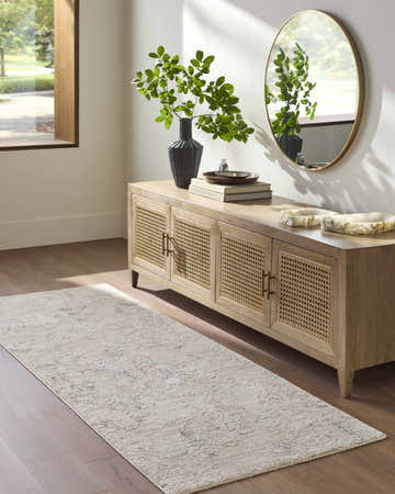 Entryway with wood floors and Breeda Charcoal Area Rug runner styled beneath a console table with a round mirror. Roomscene-Runner