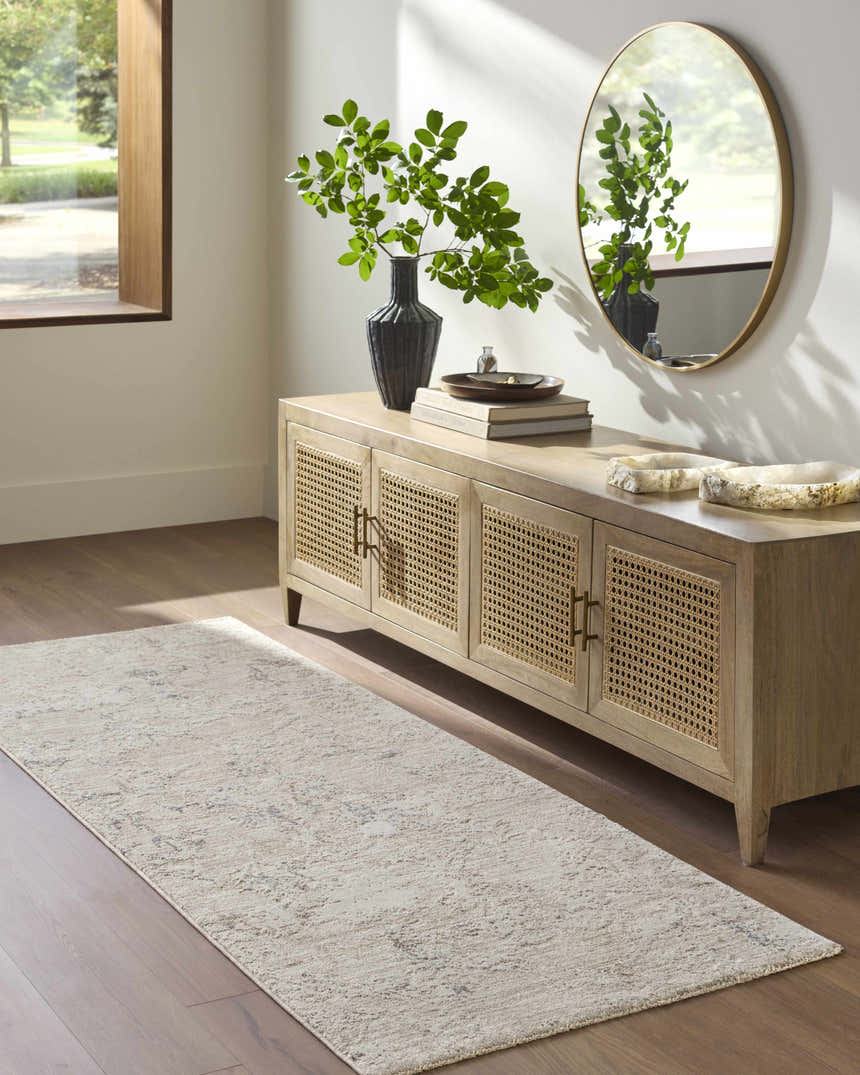 Entryway with wood floors and Breeda Charcoal Area Rug runner styled beneath a console table with a round mirror. Roomscene-Runner