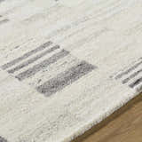 Close-up of the Max Handmade Becki Owens x LIVABLISS BOMX-2305 Area Rug, showing ash and charcoal stripes on cream wool. Texture