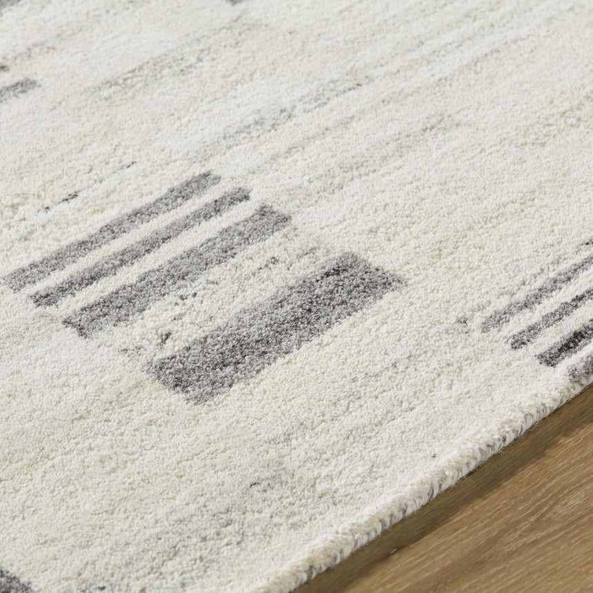 Close-up of the Max Handmade Becki Owens x LIVABLISS BOMX-2305 Area Rug, showing ash and charcoal stripes on cream wool. Texture
