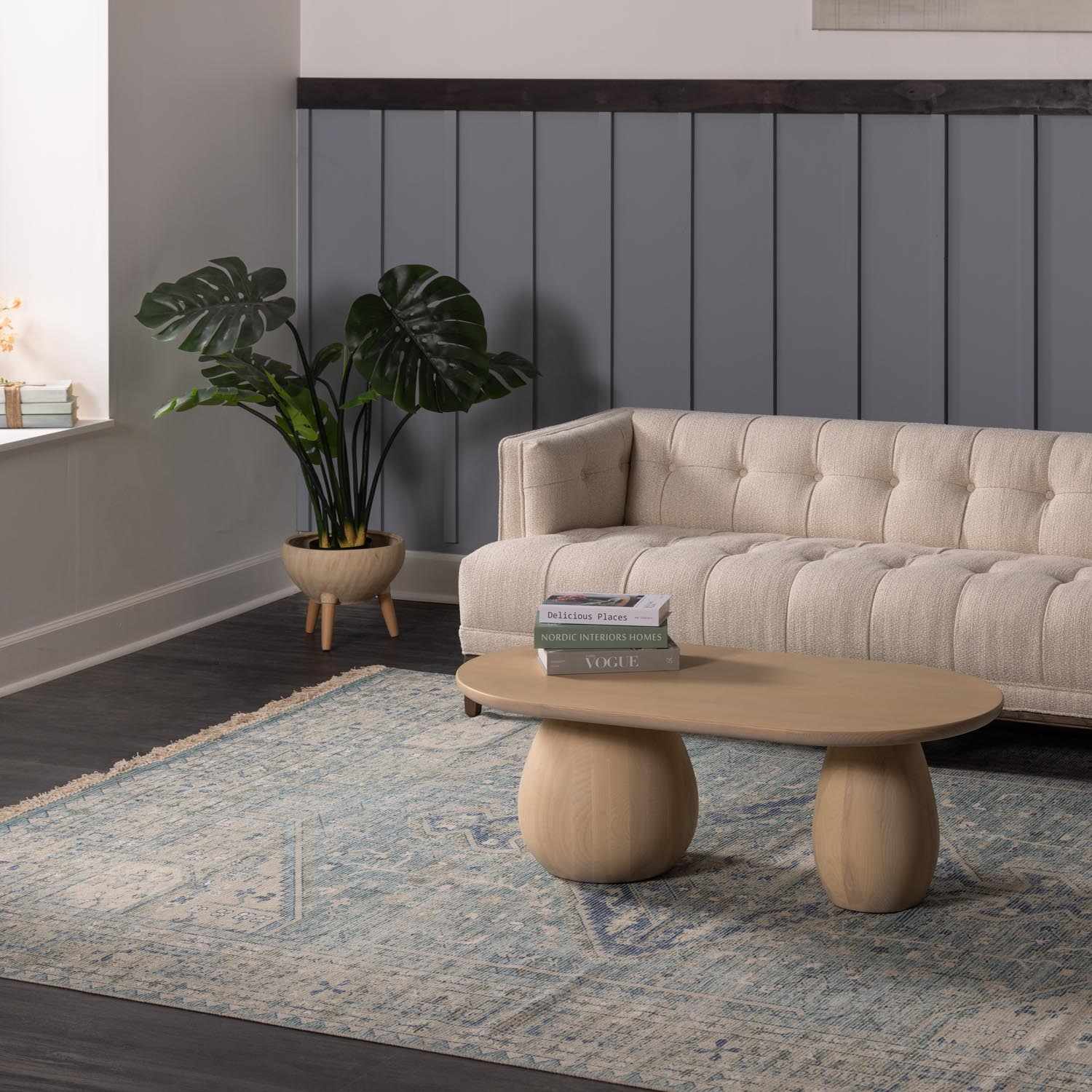 Living room scene with a Byers Handmade Cotton-blend Aqua Rug, beige sofa, and light wood coffee table. Roomscene-Rectangle