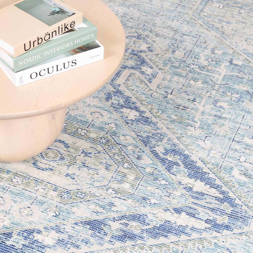 Close-up of the Byers Handmade Cotton-blend Aqua Rug showing its bohemian, traditional pattern and texture. Aqua, blue, and green tones. Styleshot