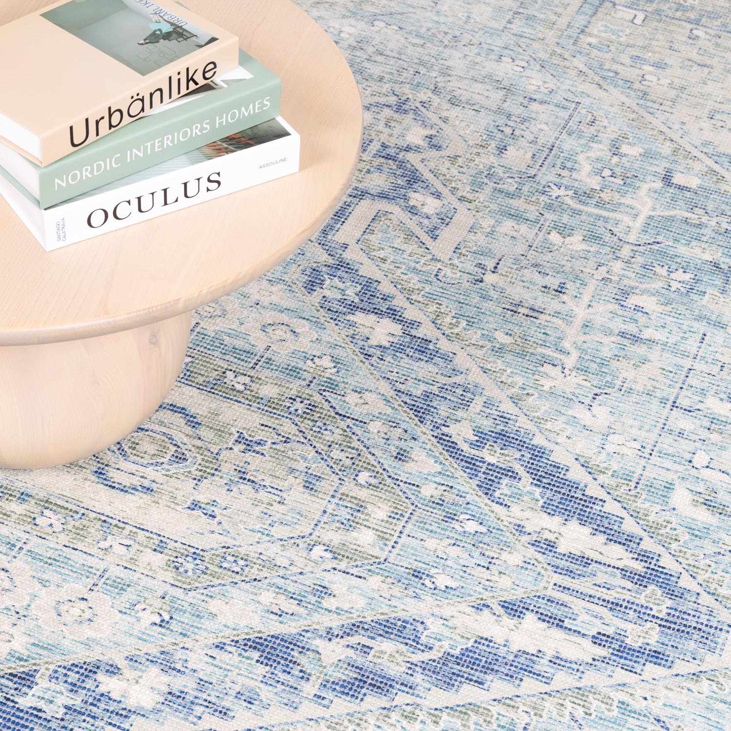 Close-up of the Byers Handmade Cotton-blend Aqua Rug showing its bohemian, traditional pattern and texture. Aqua, blue, and green tones. Styleshot
