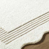 Close up of the textured Tono Ivory Border Hand Tufted Wool Area Rug with beige stripes on hardwood floor. Texture
