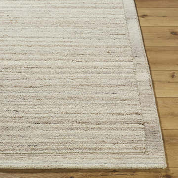 Close-up of the hand-tufted Blenda Cream Area Rug showing its beige, cream, and tan colors and wool texture. Front