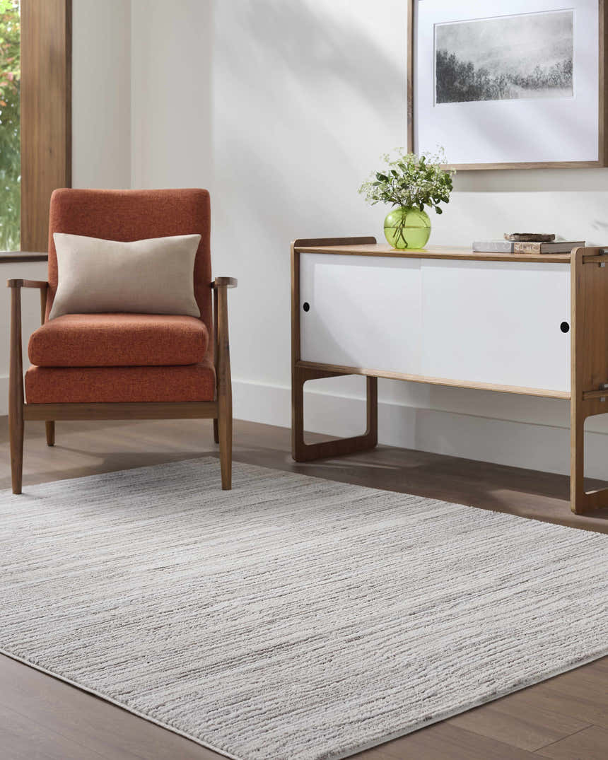 Living room scene with a light gray Bedros Area Rug, orange chair, and modern white cabinet. Roomscene-Rectangle