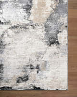 Close-up of the Birdie Area Rug. Contemporary style with ash, light silver, sage, and silver gray colors. Corner