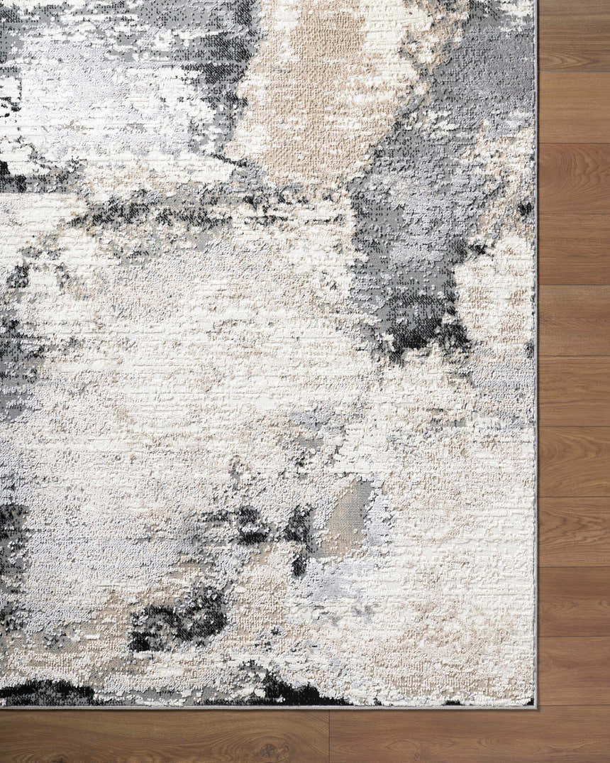 Close-up of the Birdie Area Rug. Contemporary style with ash, light silver, sage, and silver gray colors. Corner