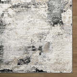 Close up of the Birdie Area Rug. Ash, light silver, sage, and silver gray abstract pattern. Contemporary style. Corner