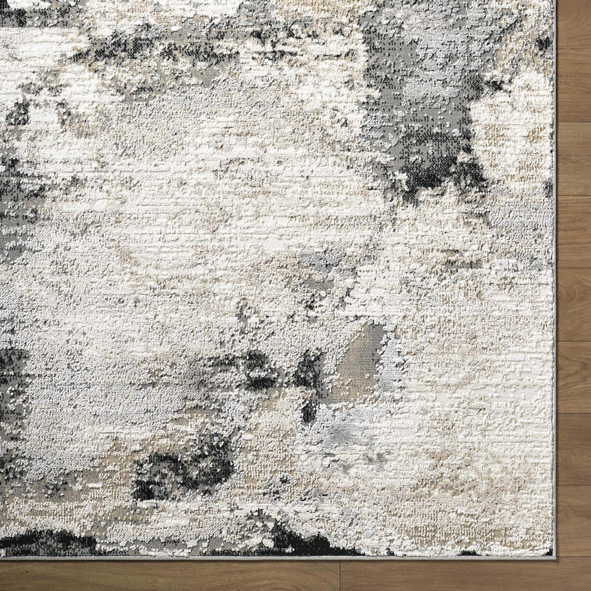Close up of the Birdie Area Rug. Ash, light silver, sage, and silver gray abstract pattern. Contemporary style. Corner