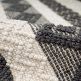 Close-up of the Whittington Black&White Wool Rug showing its textures, black geometric patterns, and ivory wool knots. Fold