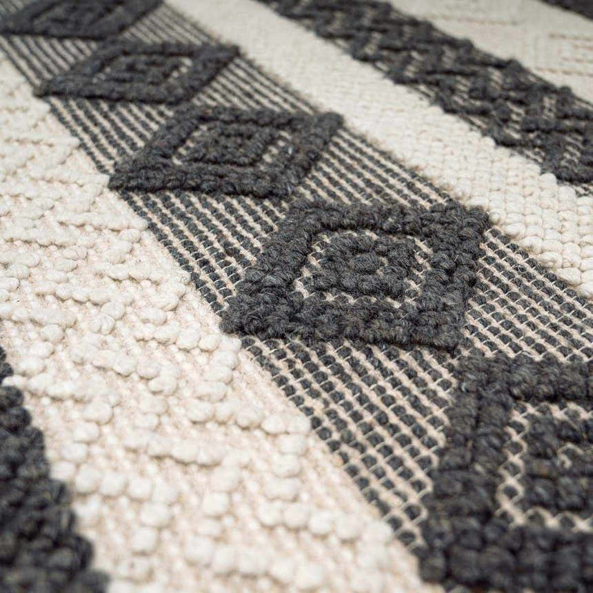 Close-up of the Whittington Black&White Wool Rug showing the diamond pattern, wool texture, and hand-woven construction. Texture