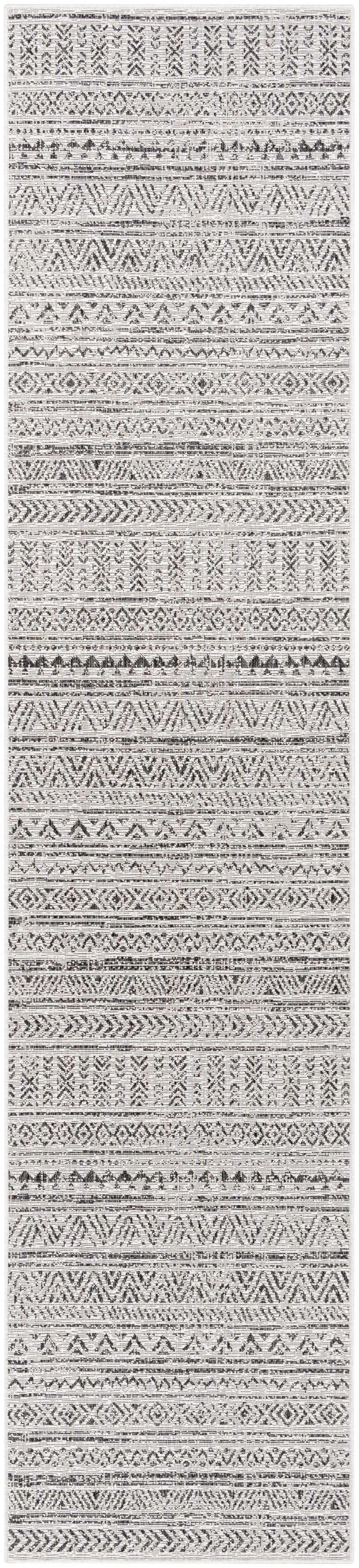Close-up of the Catrine Indoor & Outdoor Rug. Bohemian style with black, charcoal, and off-white geometric patterns. Design-Runner-2712