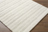 Close up of the hand woven Coskun Area Rug, a farmhouse style rug in creamy white wool. Corner