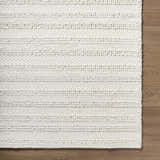 Close up of the hand woven, white, wool Coskun Area Rug showing the textured, farmhouse design. Corner