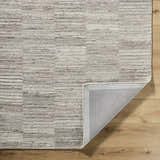 Close-up of the hand-tufted Andred Taupe Area Rug showing its beige, cream, and tan horizontal stripe design and wool texture. Fold