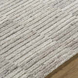 Close up of the hand tufted Andred Taupe Area Rug. Beige, cream, and tan wool rug with a subtle striped pattern. Texture