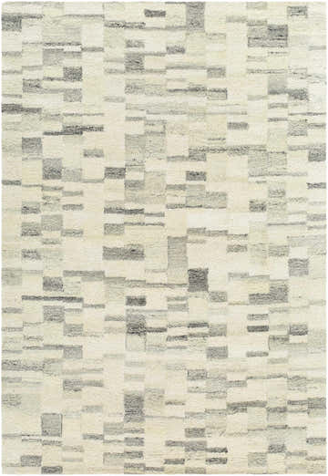 Close-up of the Max Handmade Becki Owens x LIVABLISS rug. Hand-tufted wool rug in blue, charcoal, dove gray, and ivory. Contemporary style. Design-Rectangle-576