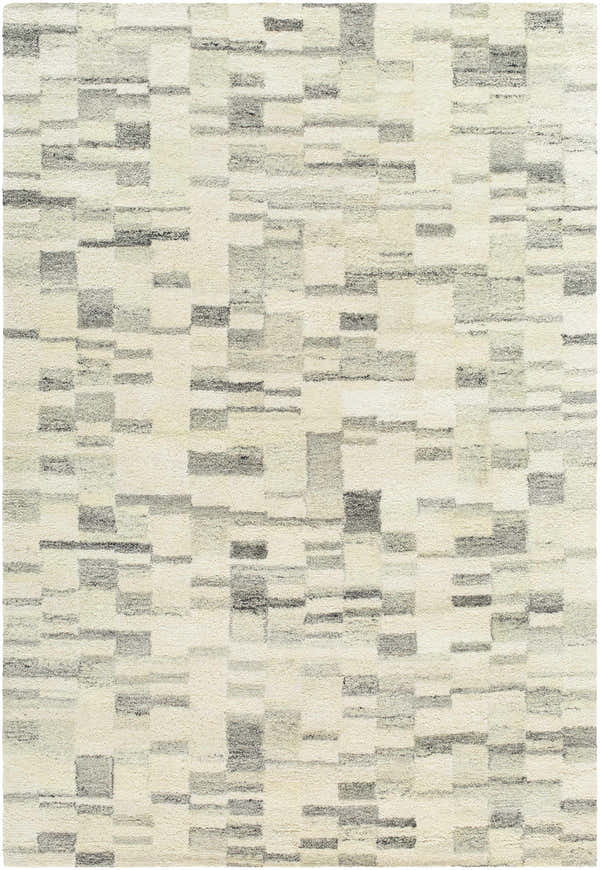 Close-up of the Max Handmade Becki Owens x LIVABLISS rug. Hand-tufted wool rug in blue, charcoal, dove gray, and ivory. Contemporary style. Design-Rectangle-576