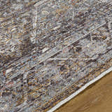 Close-up of the Clovia Area Rug showing its black, gray, ivory, and brown traditional pattern and soft texture. Texture